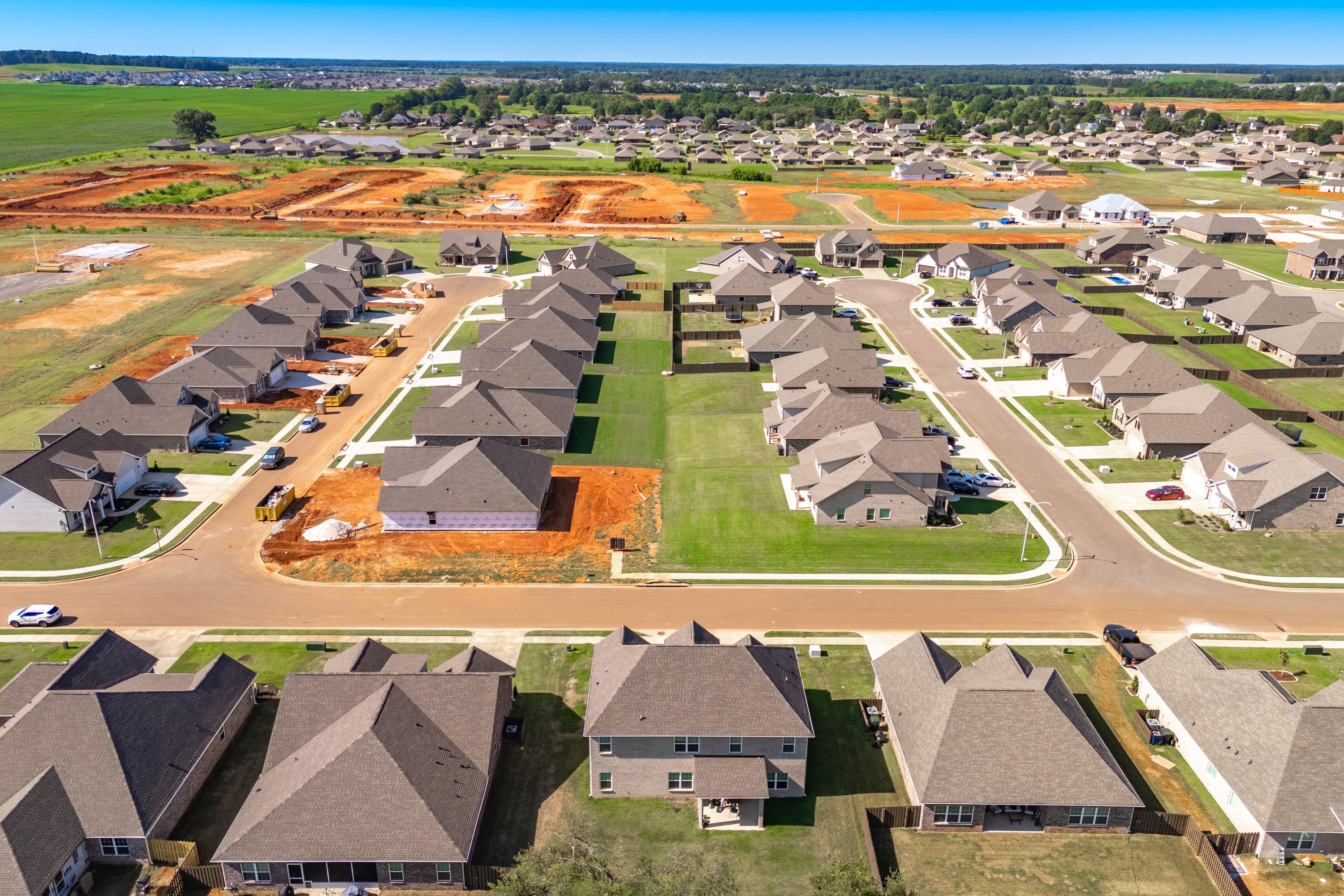Aerial view of new homes under construction in Pikes Ridge, Meridianville Alabama by Davidson Homes with streets and surrounding fields
