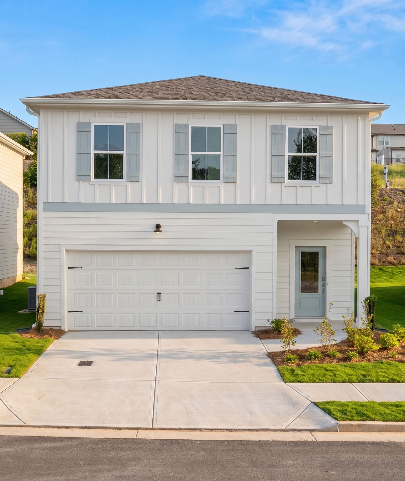 Modern white farmhouse exterior by Davidson Homes at Greene Farm in Cartersville, Georgia with two-car garage.