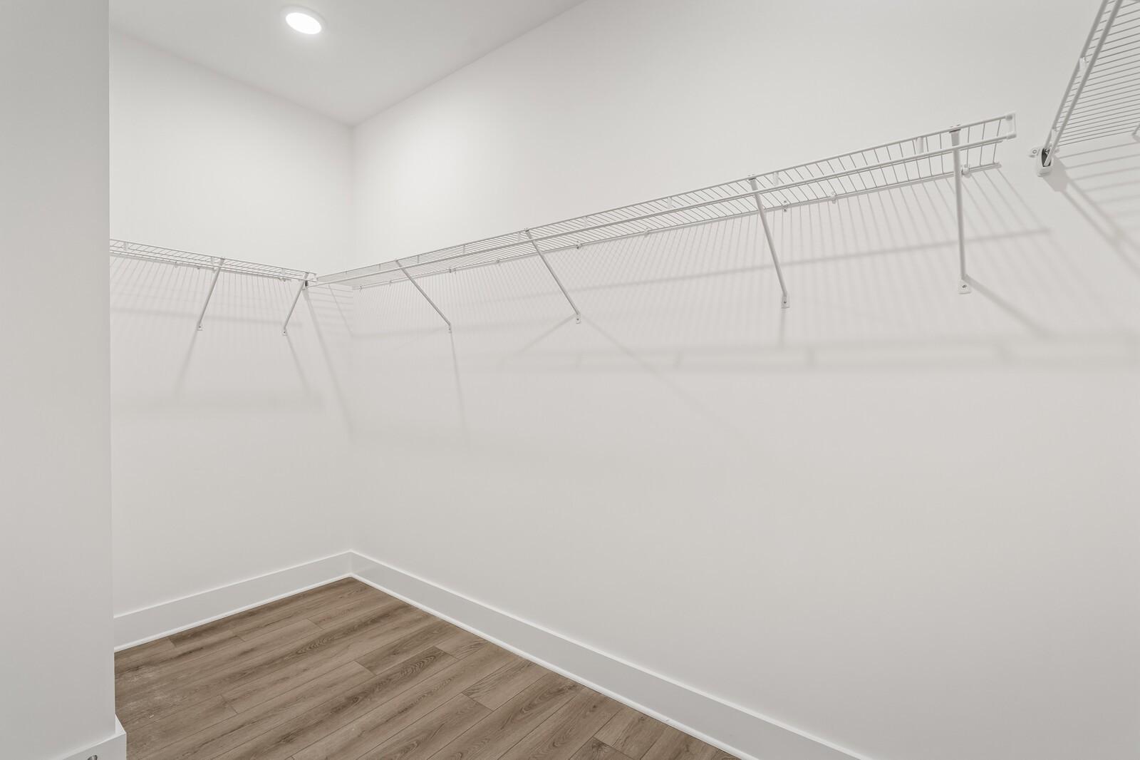 Walk-in closet with white wire shelving in The Ridgeport C floor plan at Woods Crossing, Gallatin, Tennessee.