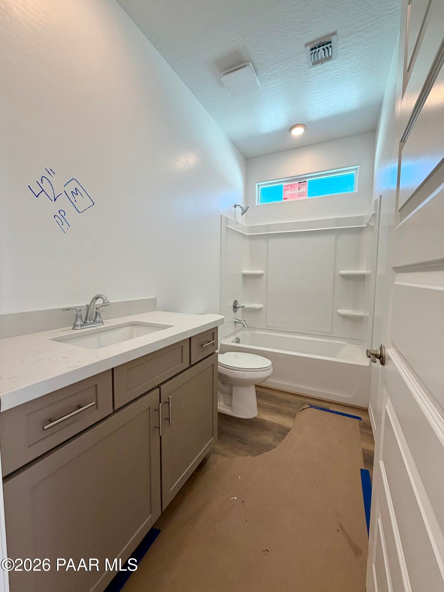 New bathroom with gray vanity, quartz countertop, tub-shower combo, and toilet in Davidson Homes Marietta C, Prescott, AZ