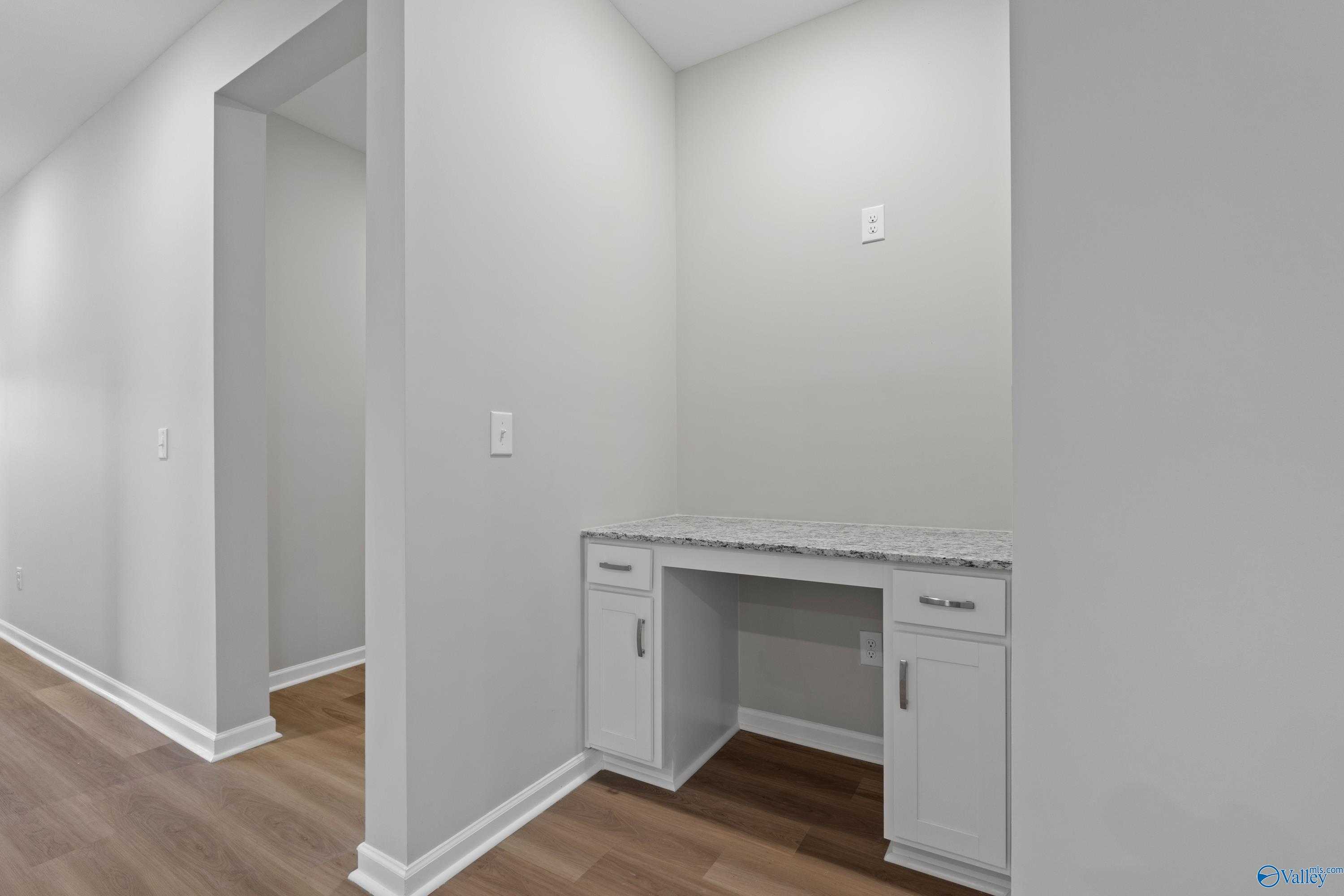 Modern built-in desk nook with white cabinets and granite countertop in master suite, Davidson Homes Phoenix, Fayetteville TN