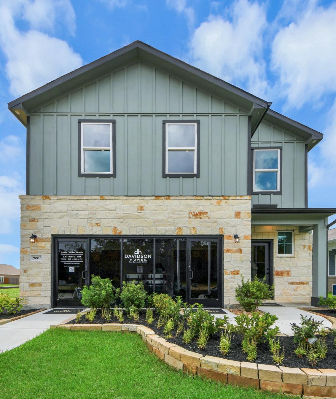 Happy family forming house shape with arms on gray sofa in modern Robins Landing living room, Houston Texas by Davidson Homes