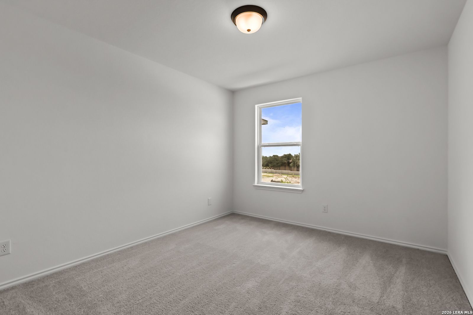Bright secondary bedroom with plush carpet and natural light in The Florence B floor plan at Meadows at Oak Creek.