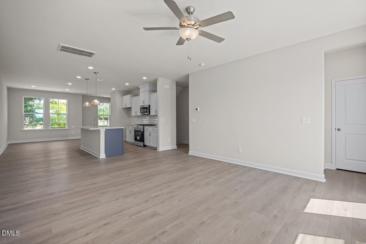 Open-concept kitchen and living area in The Mitchell floor plan by Davidson Homes at Camden Park in Knightdale, NC.