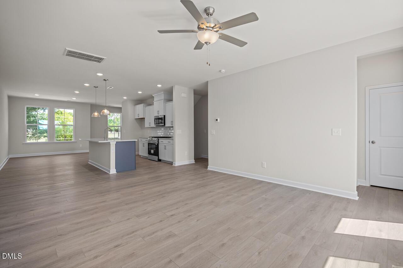 Open-concept kitchen and living area in The Mitchell floor plan by Davidson Homes at Camden Park in Knightdale, NC.