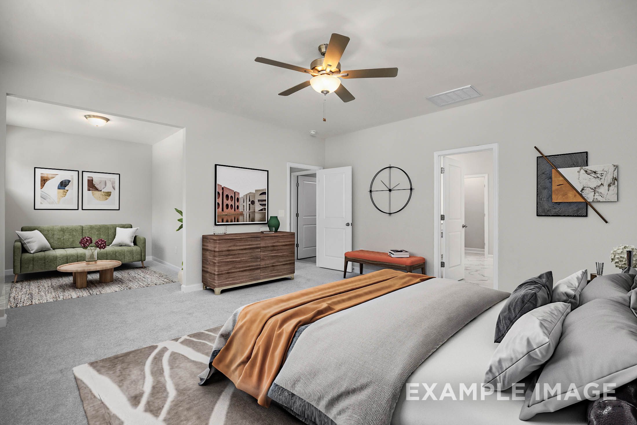 Spacious primary bedroom at Addison West in Holly Springs NC with king bed, green velvet sofa, and modern wall art