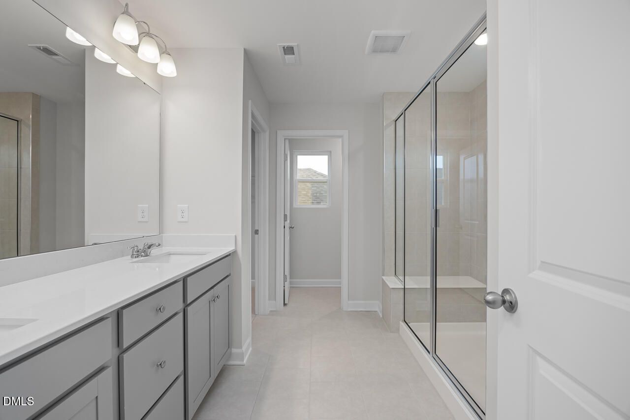 Modern master bathroom with double vanity, frameless glass shower in Davidson Homes The Gavin B, Lillington, NC