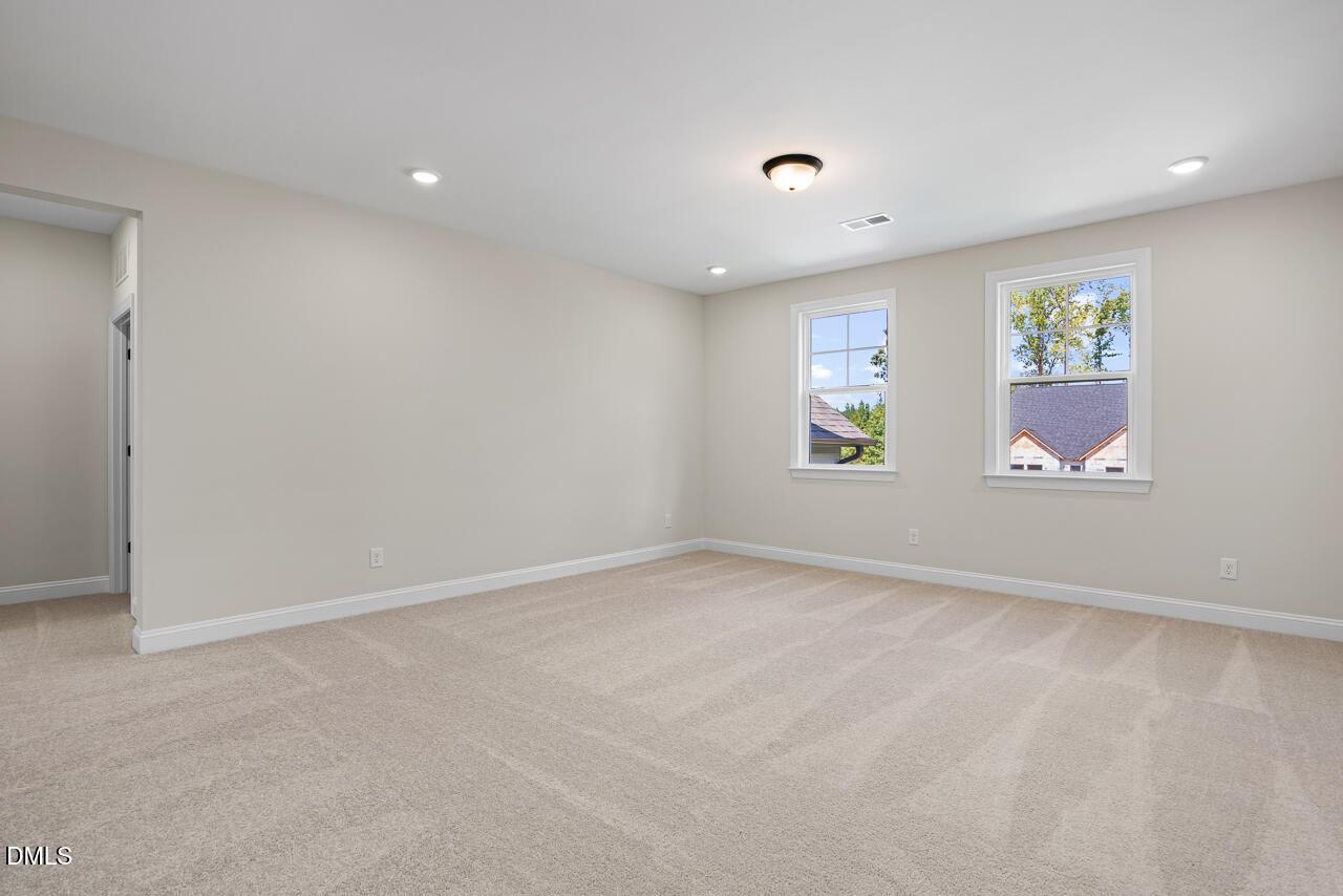 Bright spacious bedroom with carpet and dual windows in Davidson Homes Crawford D plan, Rockport, Wake Forest, North Carolina