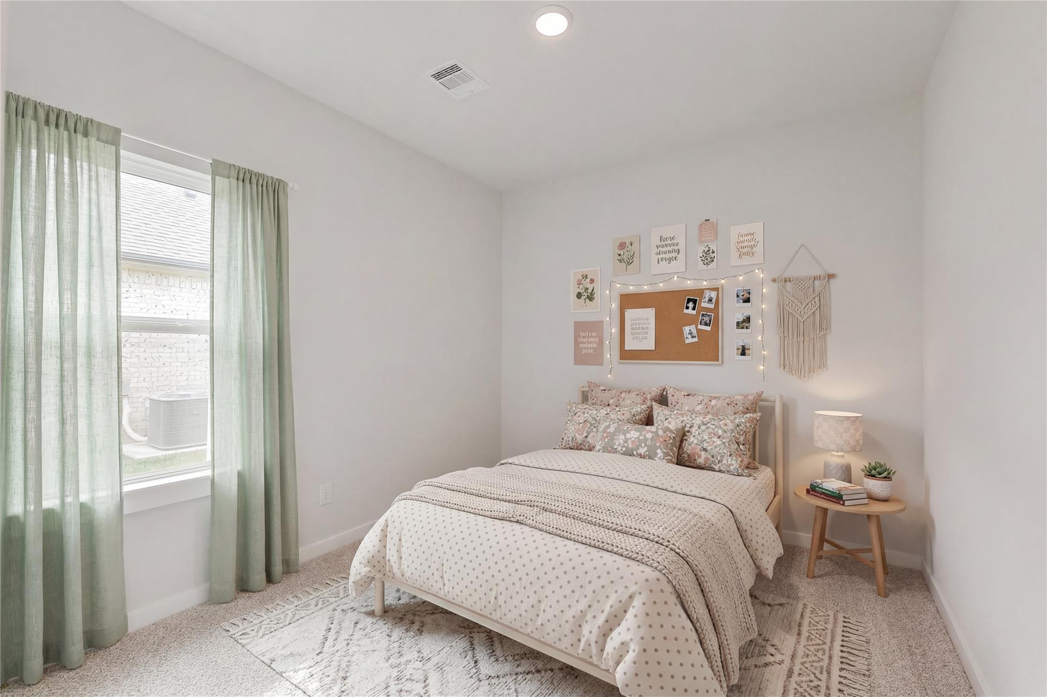 Cozy secondary bedroom with neutral decor and wall art in The Colorado G floor plan at Windmill Estates, Magnolia, Texas.
