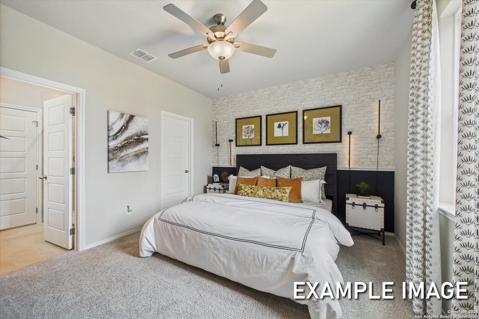 Spacious master bedroom with king bed, abstract art, ceiling fan, and walk-in closet in Davidson Homes The Sabine C, San Antonio