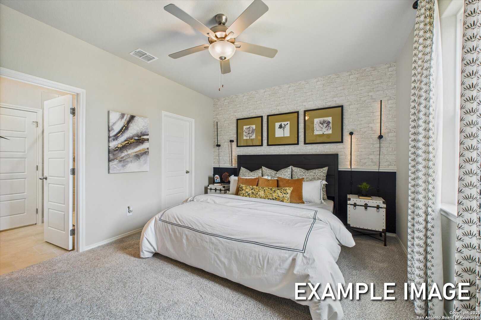 Luxurious master bedroom with king bed, abstract wall art, and ceiling fan in Davidson Homes The Sabine C, San Antonio