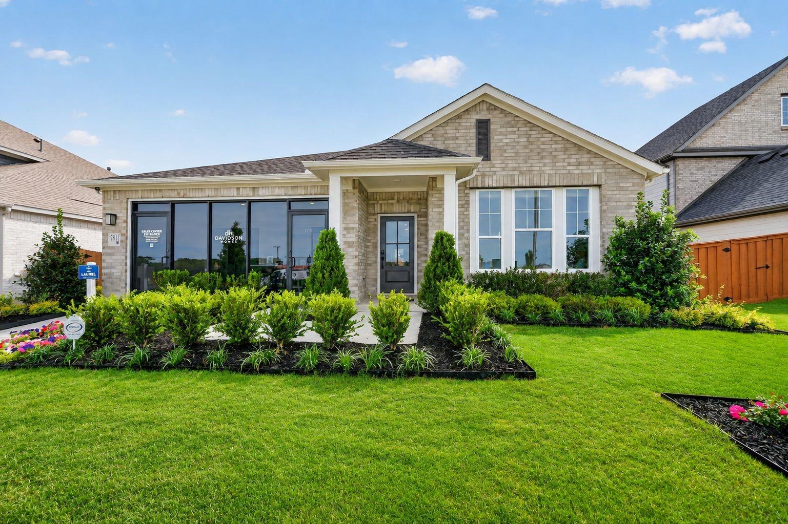 Single-story brick home featuring The Laurel I floor plan by Davidson Homes in Heartland, Texas with a manicured front lawn.