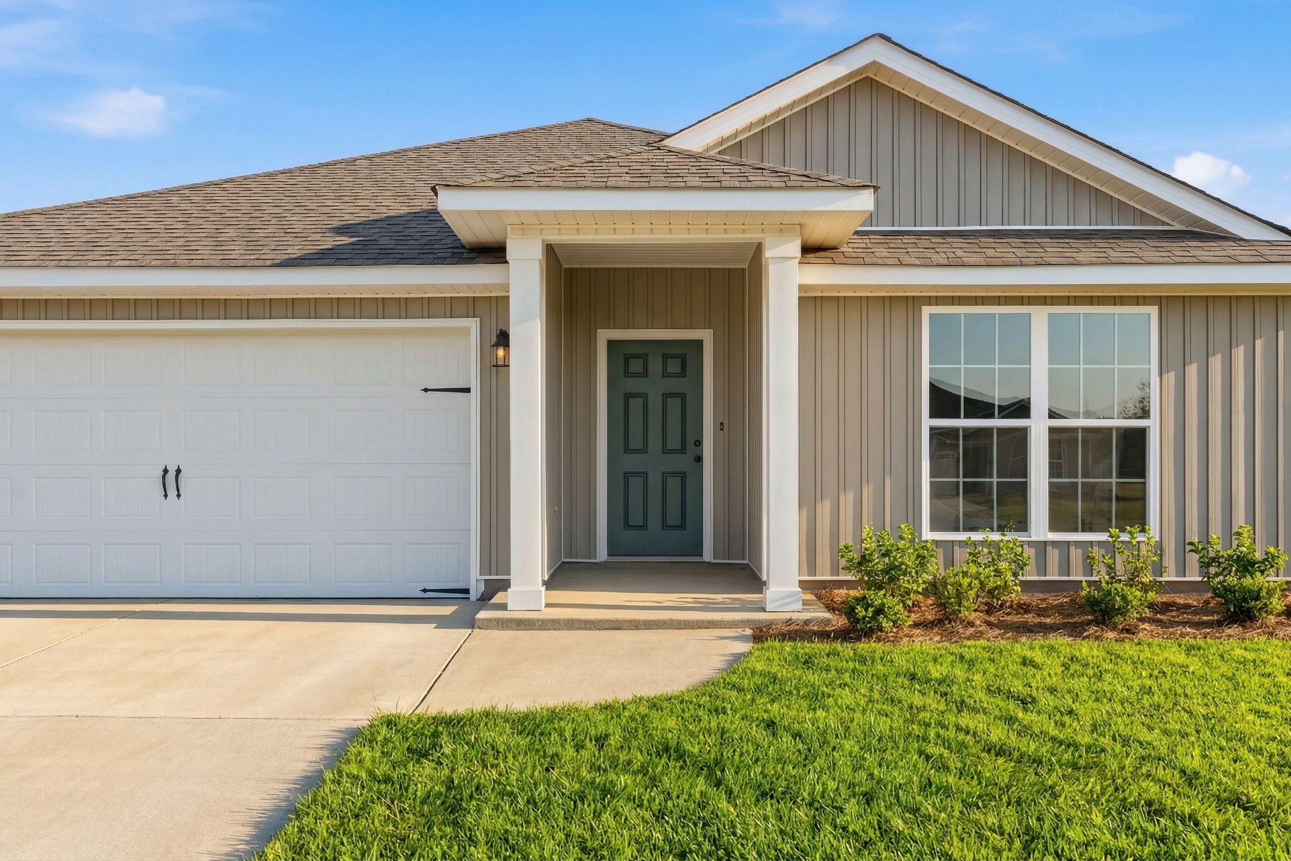 Modern craftsman home exterior at Chapel Hill in Athens Alabama by Davidson Homes with covered porch garage and landscaping