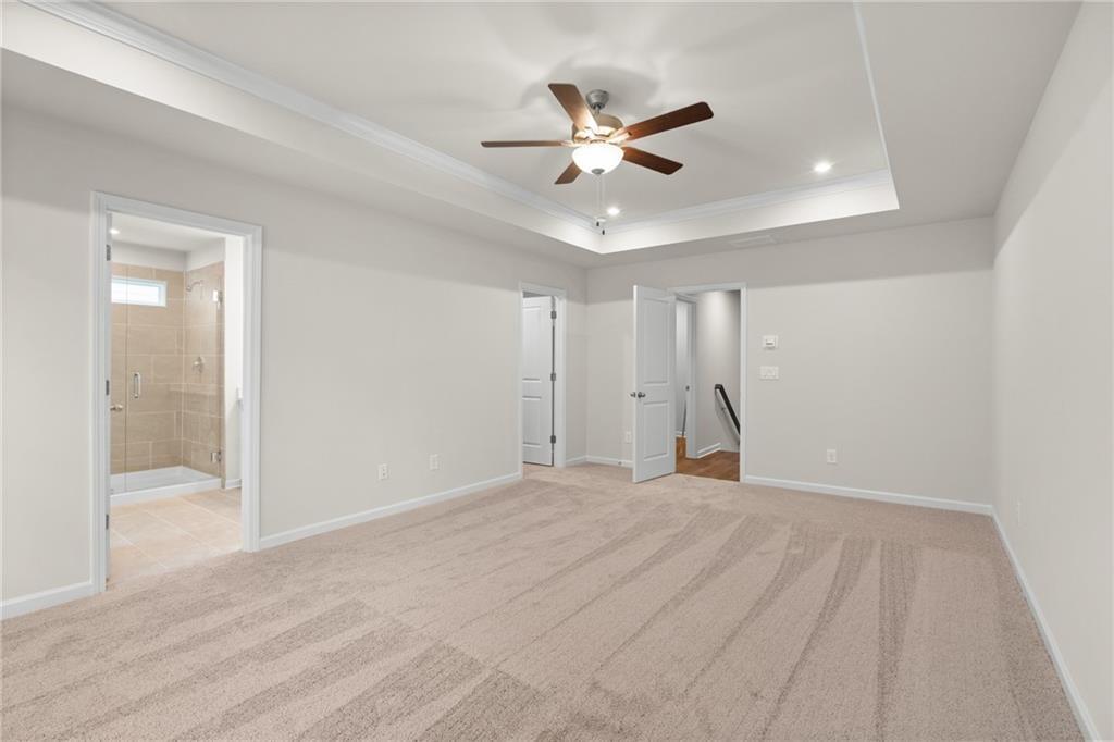 Spacious master bedroom with ceiling fan, en-suite bath, and walk-in closet in Davidson Homes The Marion B, Kennesaw, Georgia