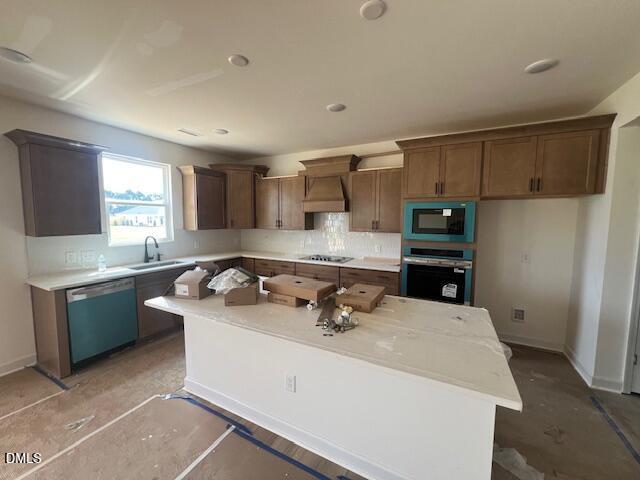 Modern kitchen with white island and brown cabinetry in The Hickory II B floor plan at Retreat at North Main, Lillington.
