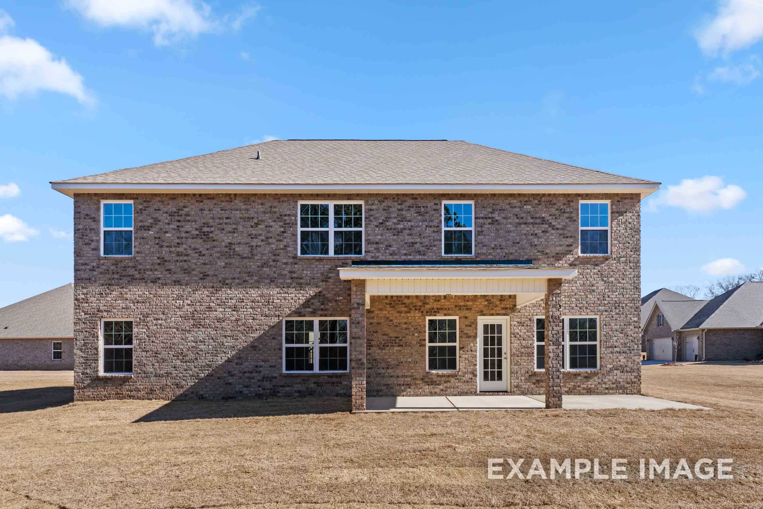 Rear elevation of The Madison B two-story brick home with covered patio, large windows, and upper master suite, Davidson Homes design