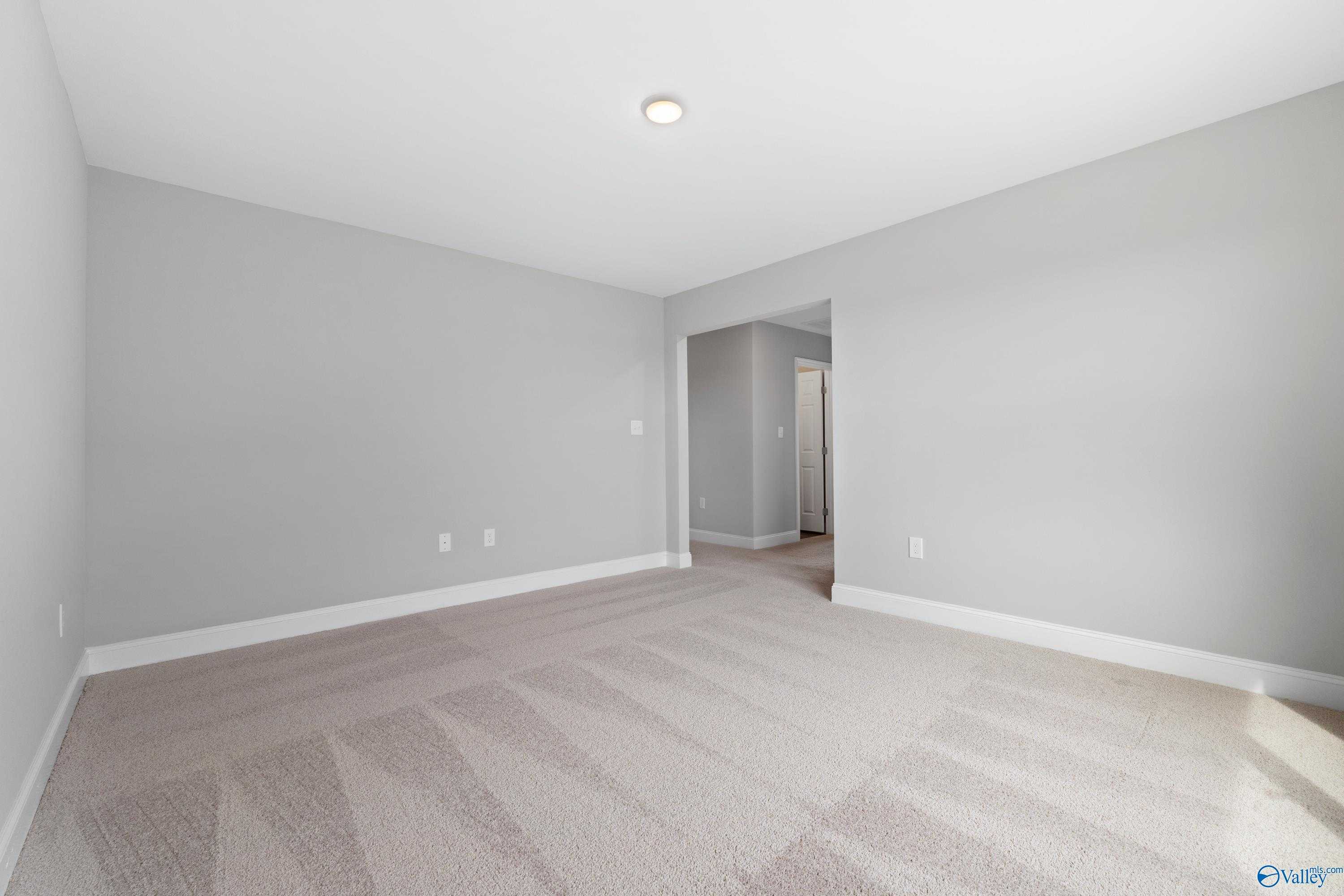 Empty bedroom with gray walls, beige carpet, and recessed lighting in Davidson Homes The Aiken, Meridianville, AL