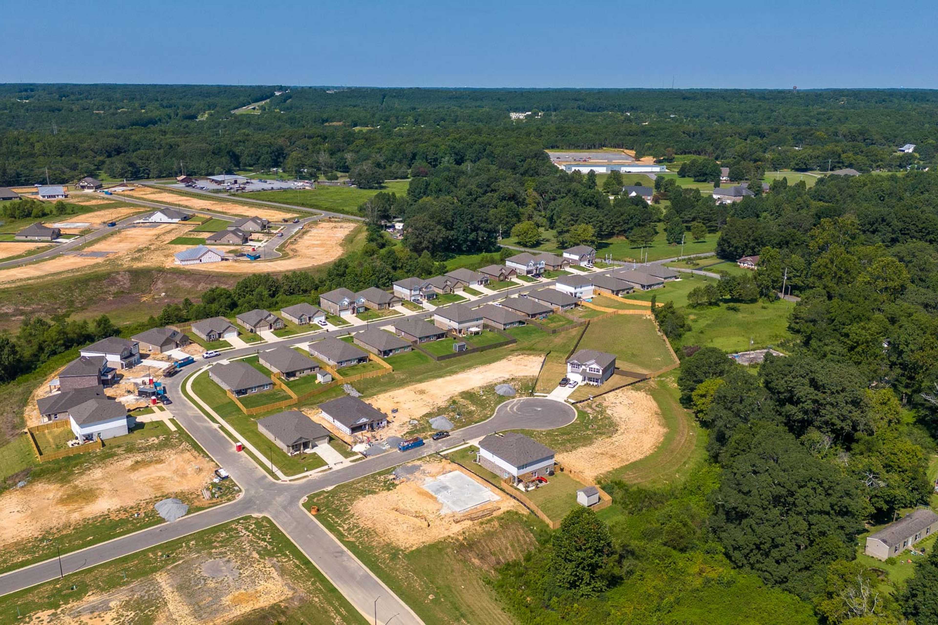 Aerial view of new single-family homes and construction sites in The Reserve at North Ridge, Cullman Alabama amid wooded surroundings