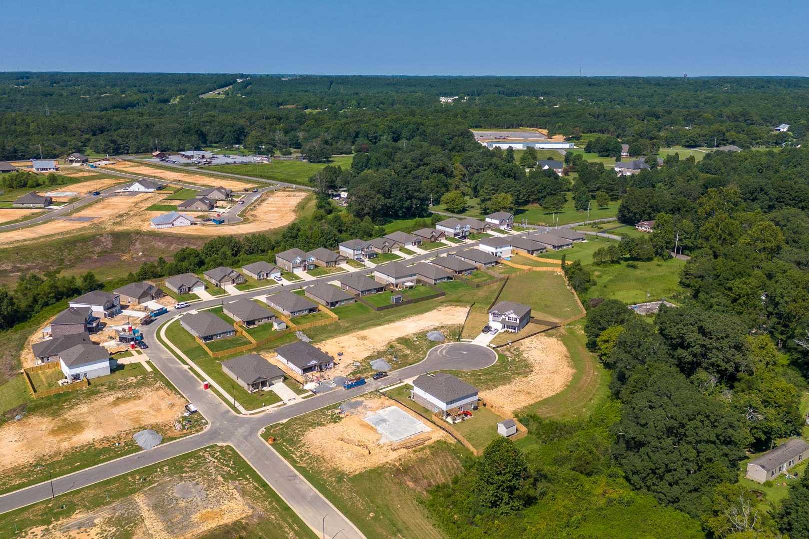 Aerial view of new single-family homes and construction sites in The Reserve at North Ridge, Cullman Alabama amid wooded surroundings