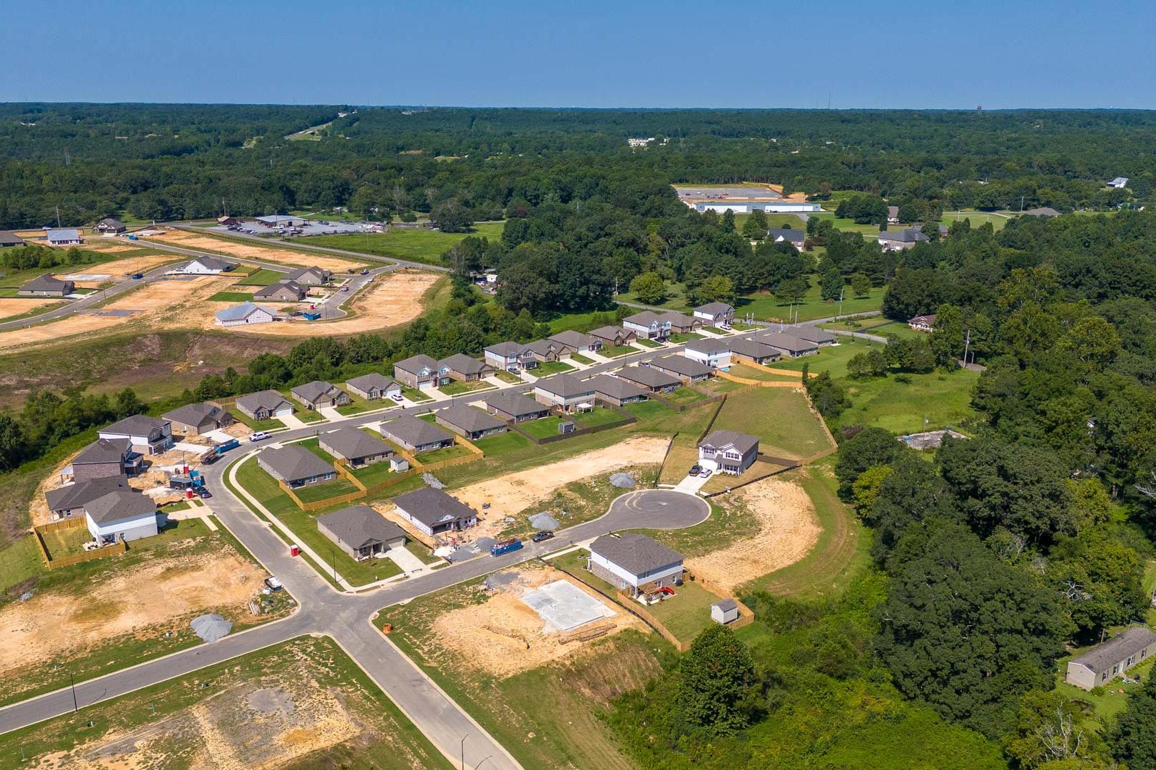 Aerial view of new single-family homes and construction sites in The Reserve at North Ridge, Cullman Alabama amid wooded surroundings