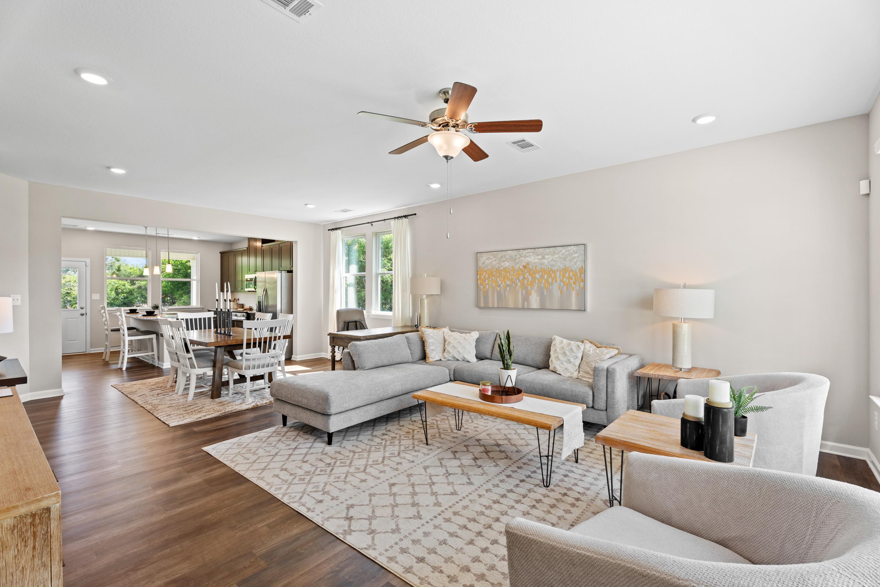 Open-concept kitchen at Ivy Glen in Perry Georgia with espresso cabinets granite island stainless appliances hardwood floors