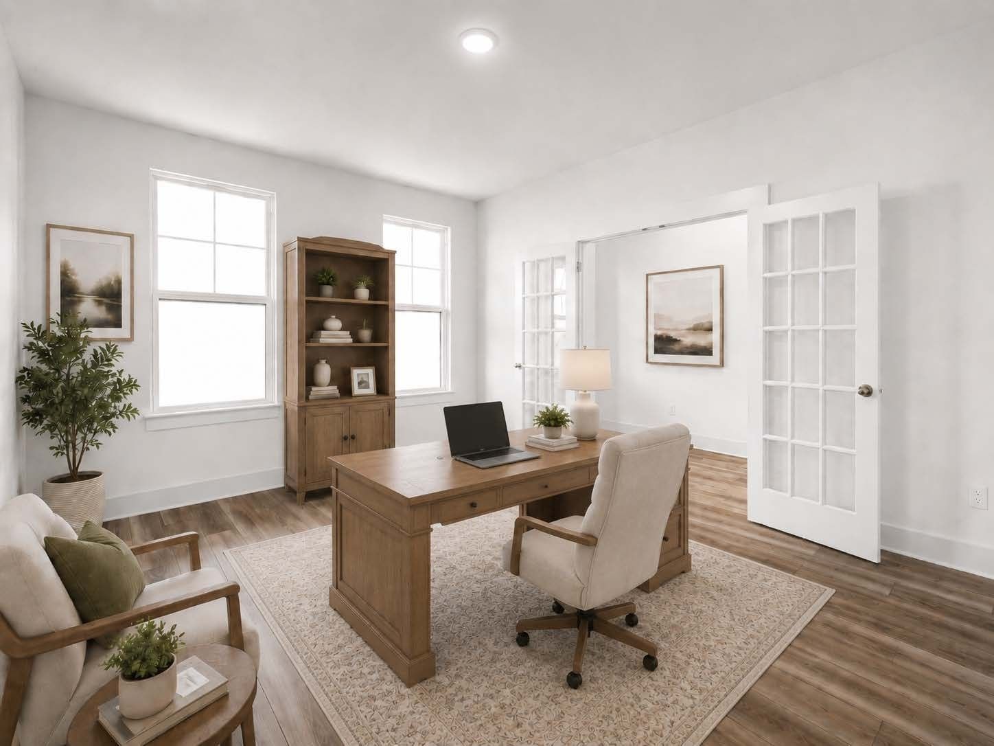 Bright home office with wooden desk and French doors in The Henry C floor plan by Davidson Homes in Mt. Juliet, Tennessee.