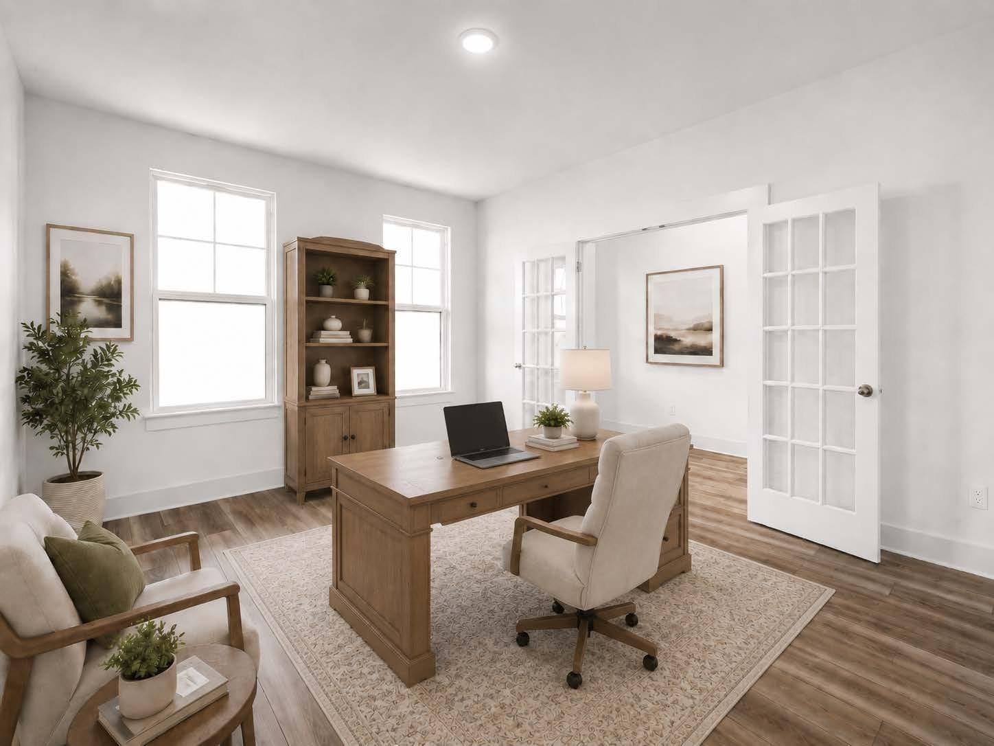 Bright home office with wooden desk and French doors in The Henry C floor plan by Davidson Homes in Mt. Juliet, Tennessee.