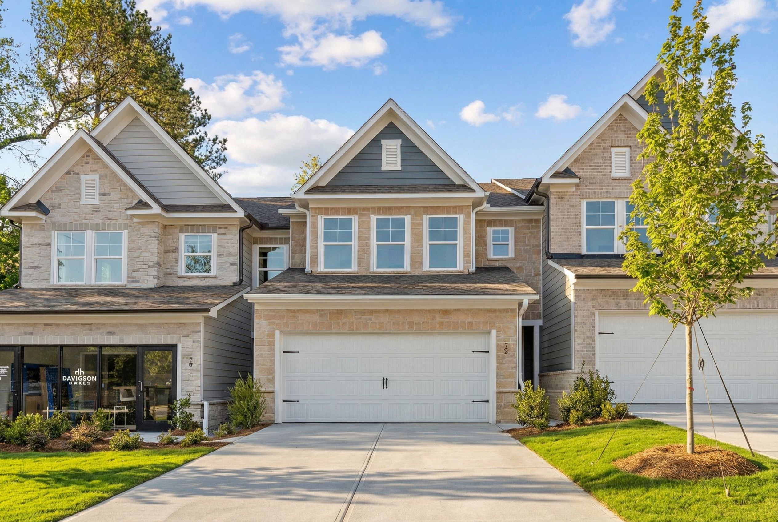 Modern 2-story Marion C home exterior featuring 2-car garage, stone accents, and driveway in Lake Shore, Winder, Georgia by Davidson Homes