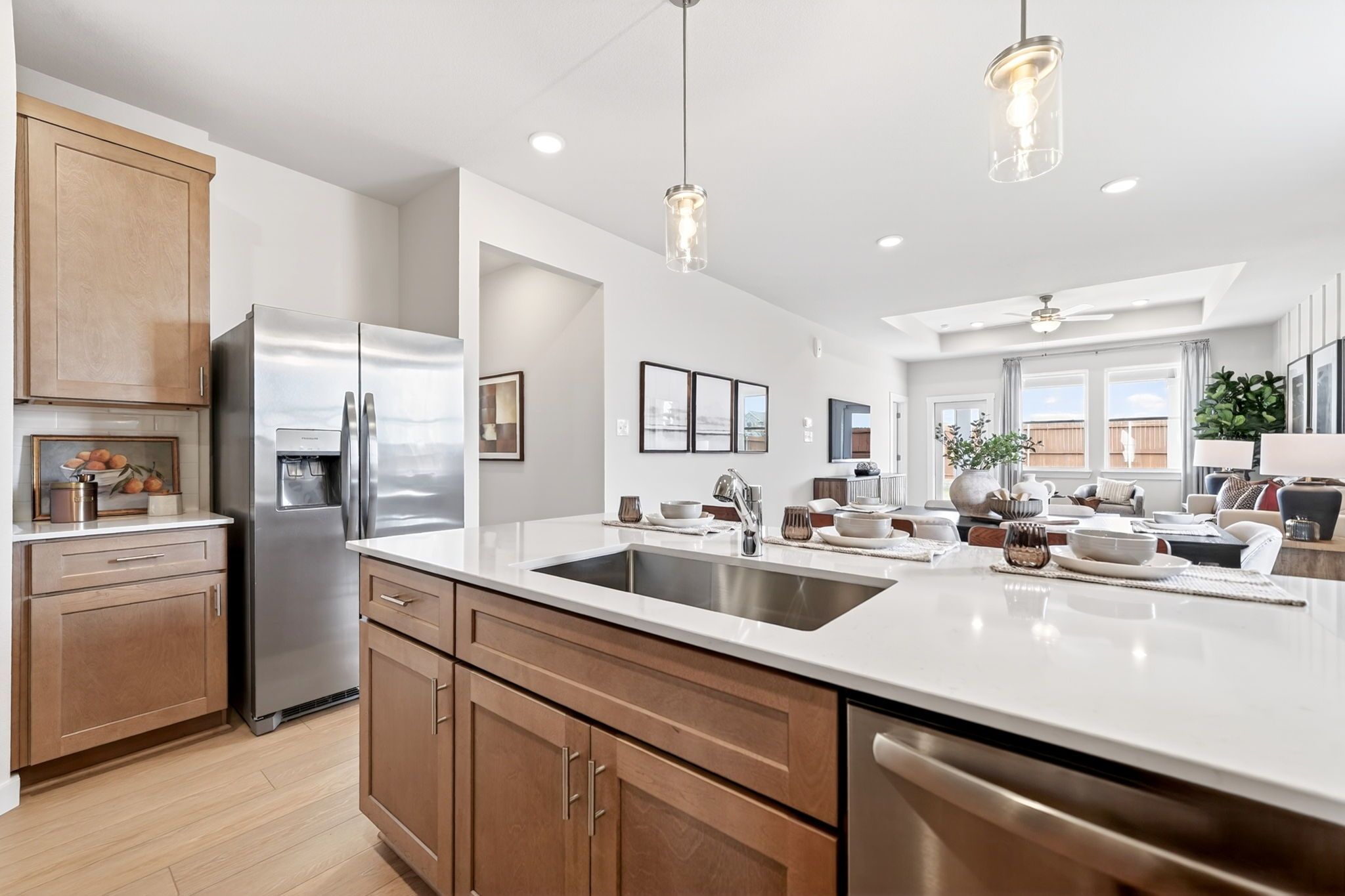 Modern kitchen with white quartz island, stainless steel appliances, and open-concept layout at Mesa Vista in San Antonio.