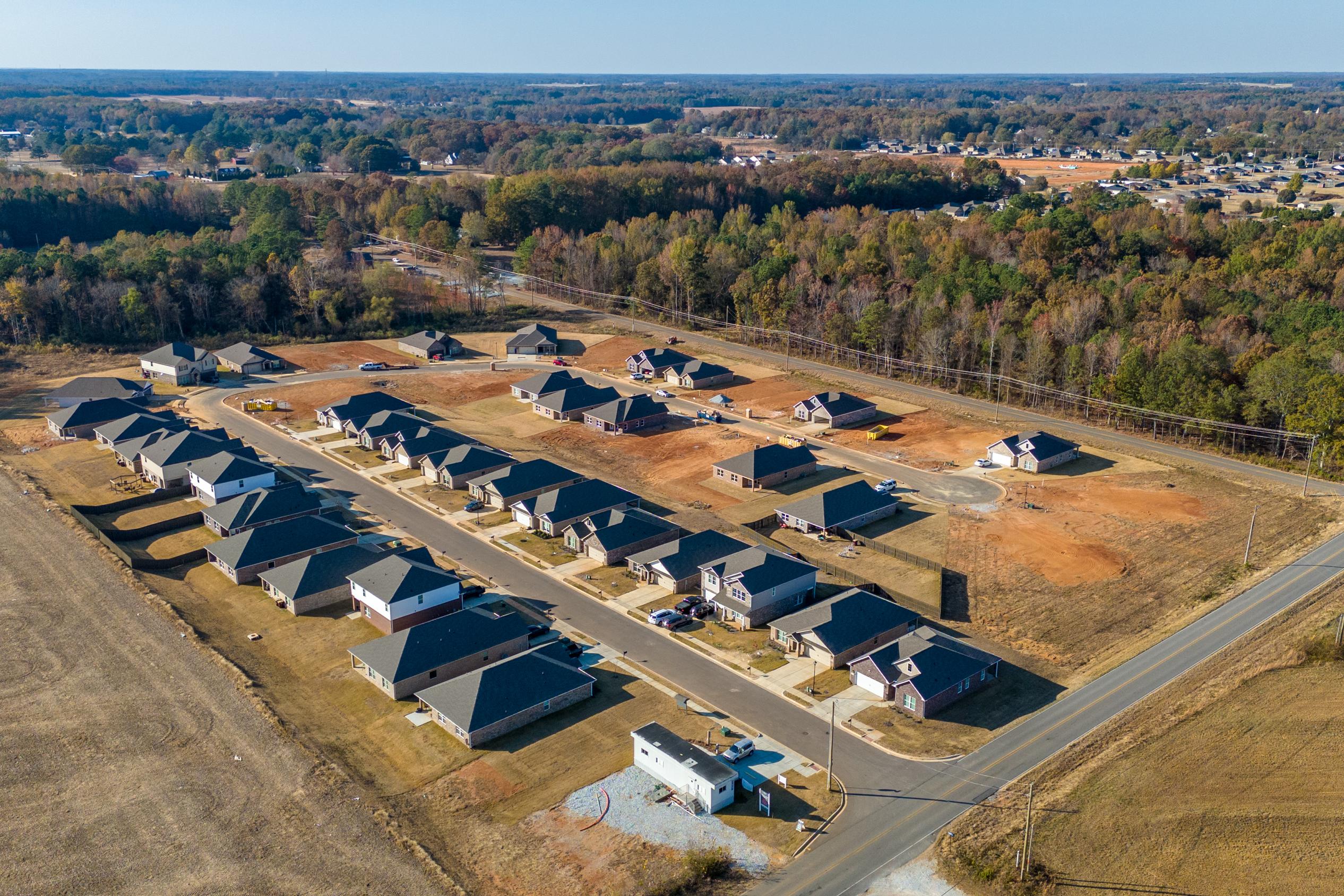Aerial view of new homes in Mallard Landing Athens Alabama by Davidson Homes with surrounding fields and autumn woods