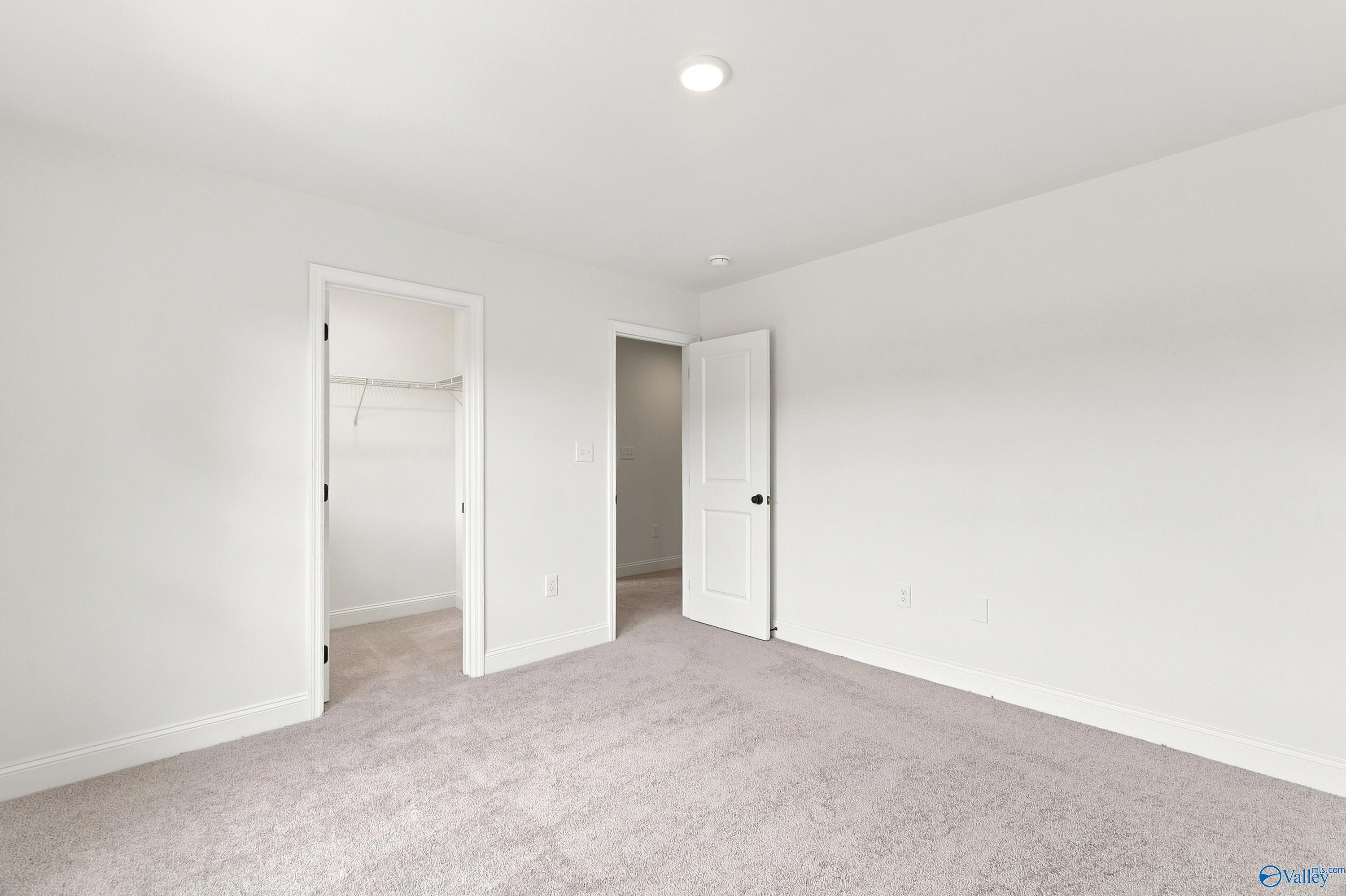 Spacious bedroom with walk-in closet in The Shelby B floor plan at Jaguar Hills, Huntsville, Alabama.