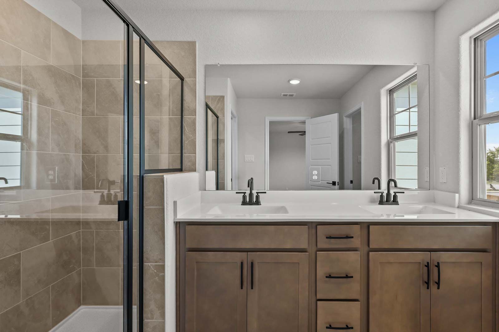 Master bathroom in The Florence B featuring a double vanity, modern fixtures, and a tiled walk-in shower.
