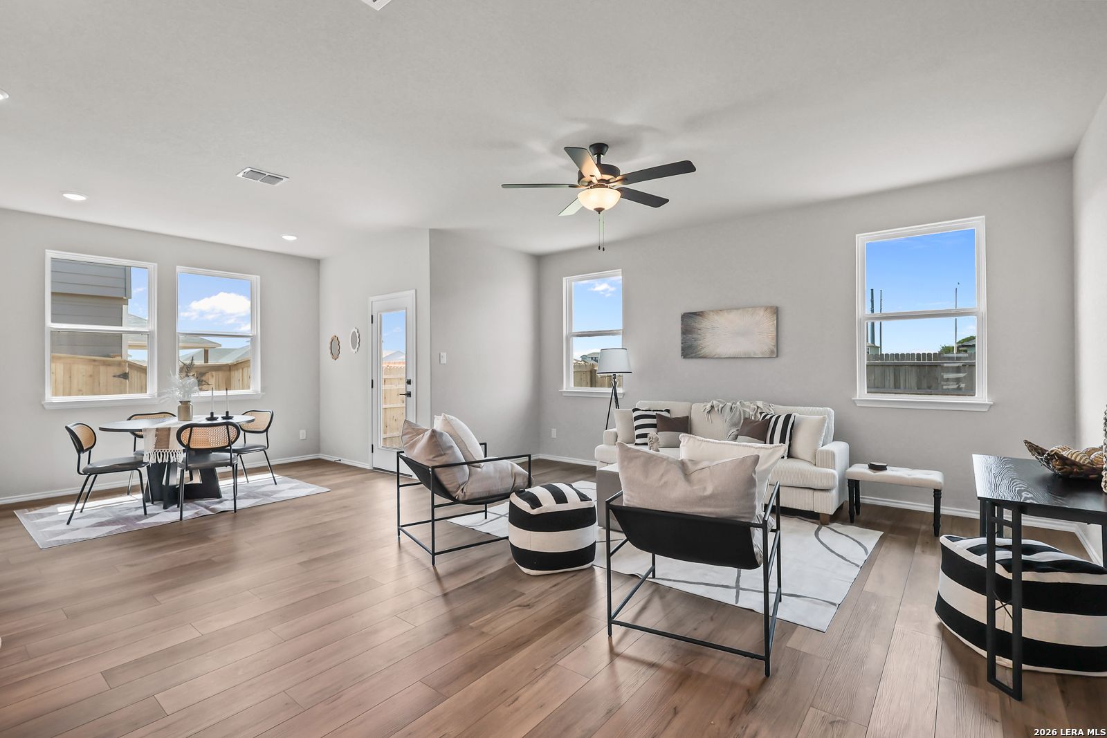 Open-concept living and dining area with modern decor in The Daphne H floor plan at Hannah Heights, Seguin, Texas.