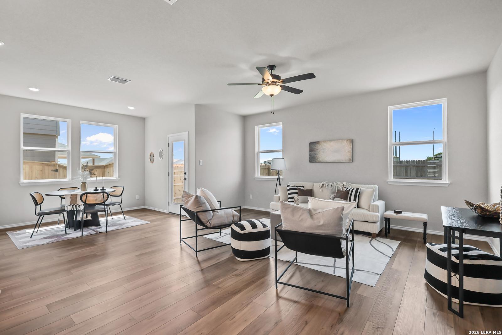 Open-concept living and dining area with modern decor in The Daphne H floor plan at Hannah Heights, Seguin, Texas.