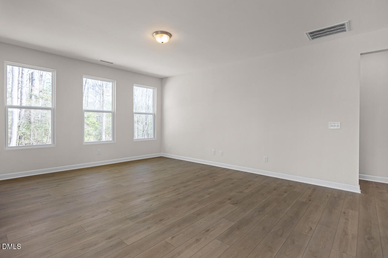 Spacious living room with hardwood floors, large windows and natural light in The Ash B floor plan, Lillington, NC