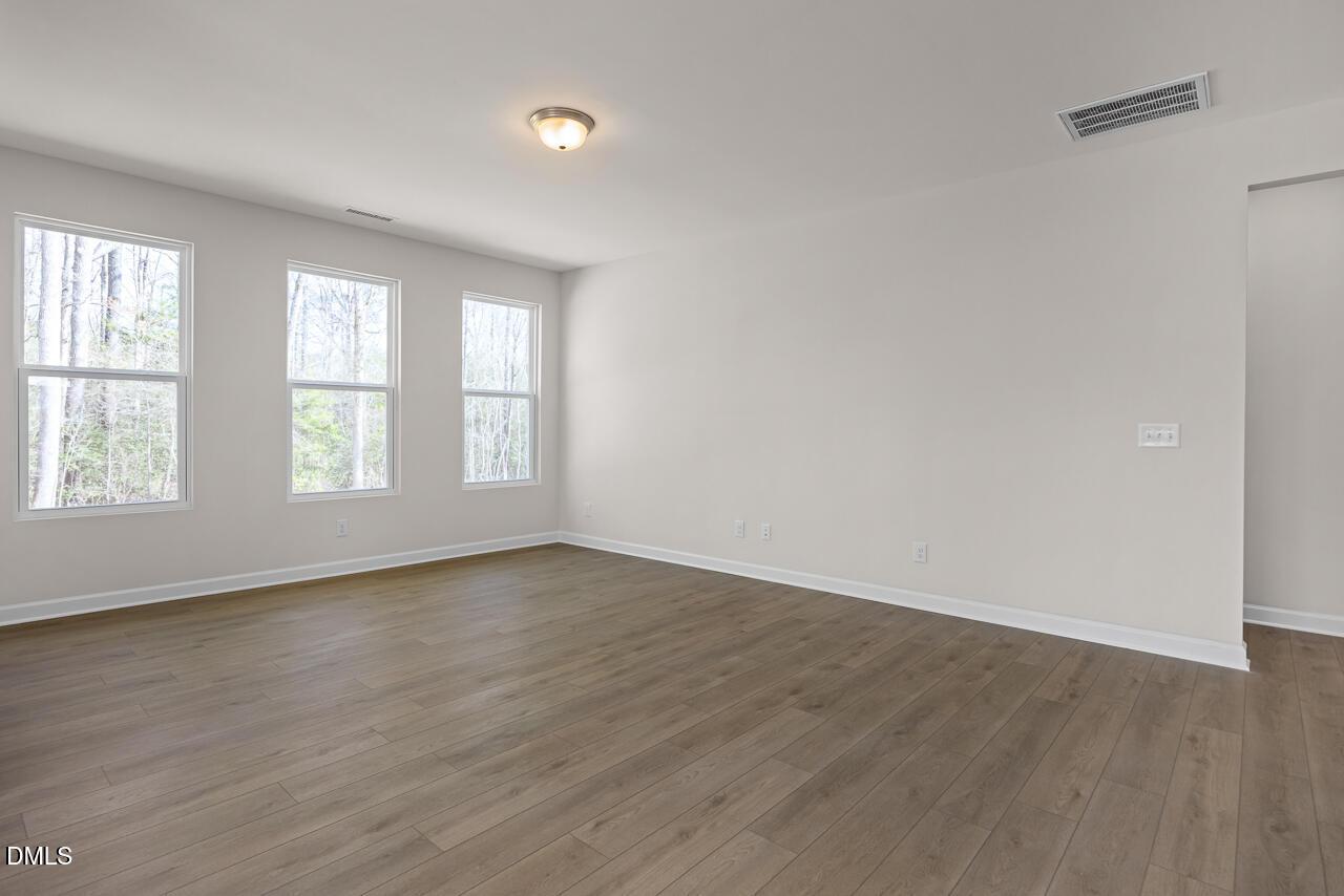 Spacious living room with hardwood floors, large windows and natural light in The Ash B floor plan, Lillington, NC
