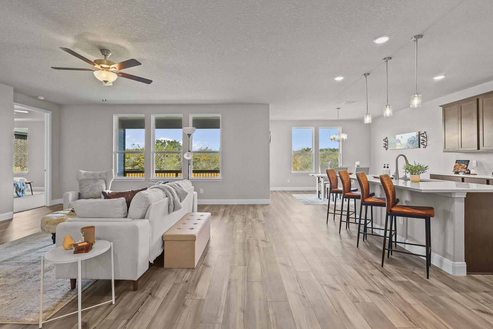 Open-concept living space in The Jennings G featuring a modern kitchen island, dining area, and spacious family room.