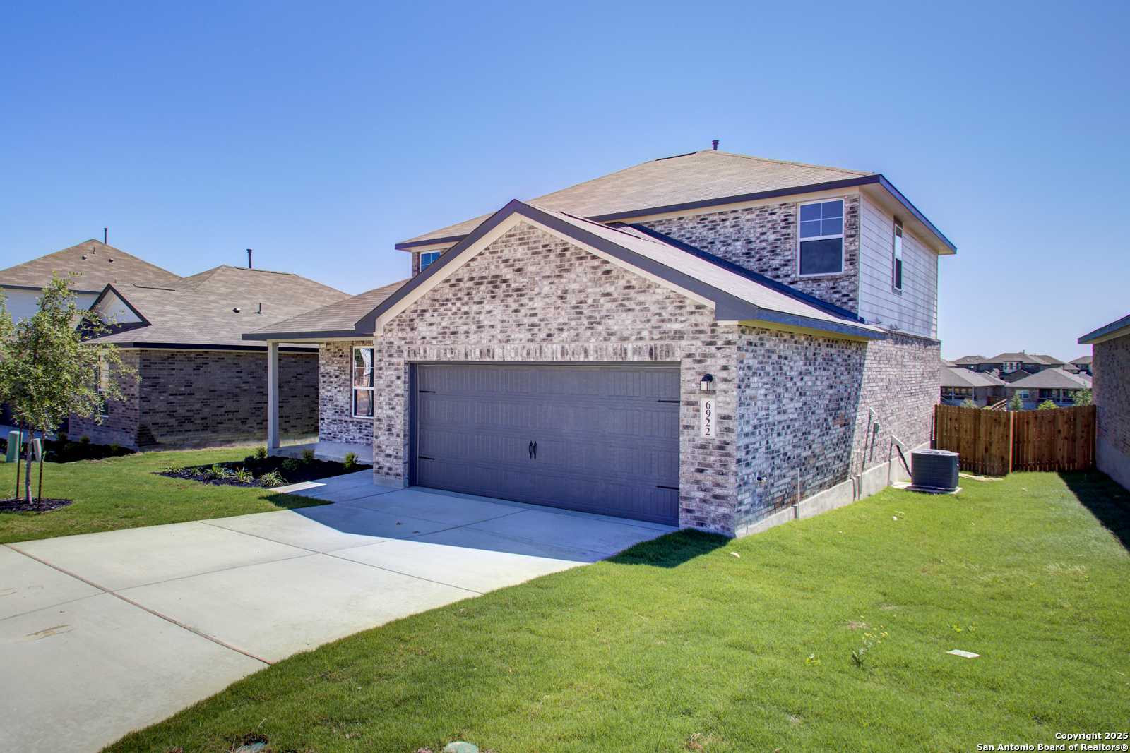 2-story brick home with attached 2-car garage and driveway in Comanche Ridge, San Antonio, Texas - Davidson Homes The Douglas G