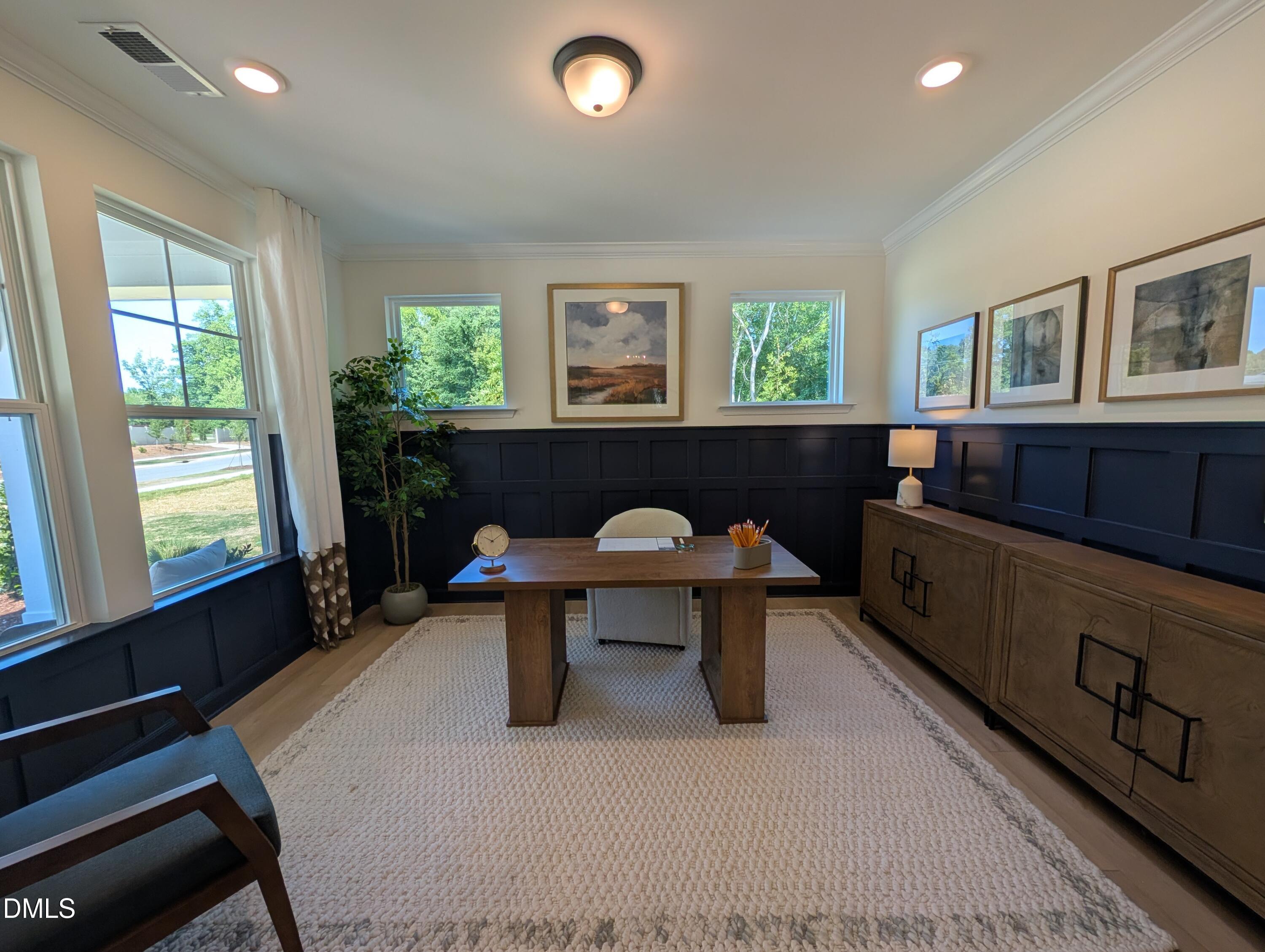 Home office with dark blue wainscoting in The Aspen B floor plan at Wendell Ridge, Wendell, North Carolina.