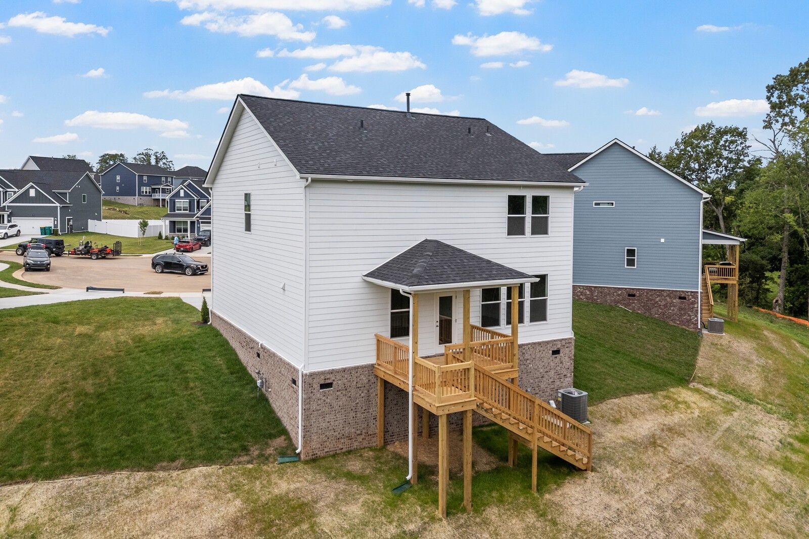 Exterior view of The Logan C floor plan by Davidson Homes featuring a raised deck in Calista Farms, White House, Tennessee.