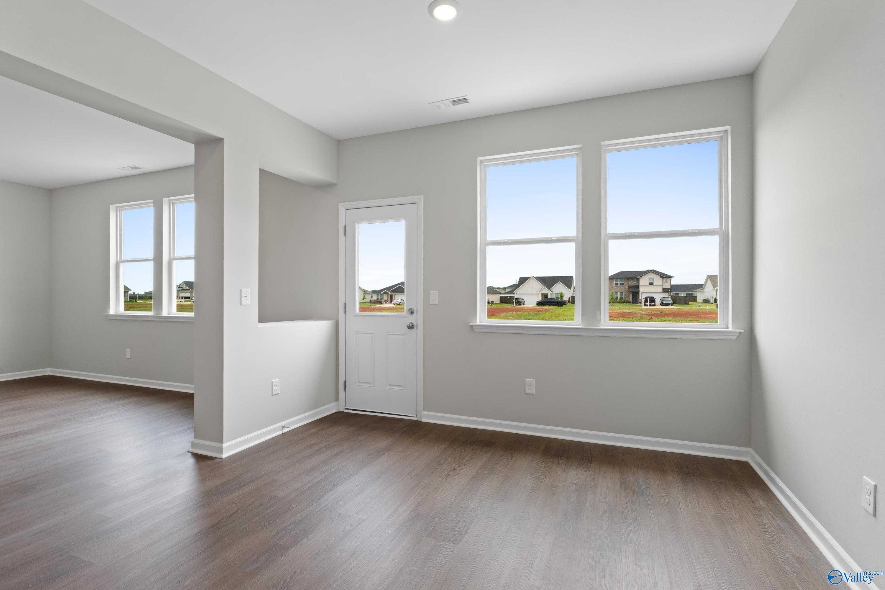 Bright bonus room with hardwood floors, large windows overlooking neighborhood in Davidson Homes The Dorado, Athens AL