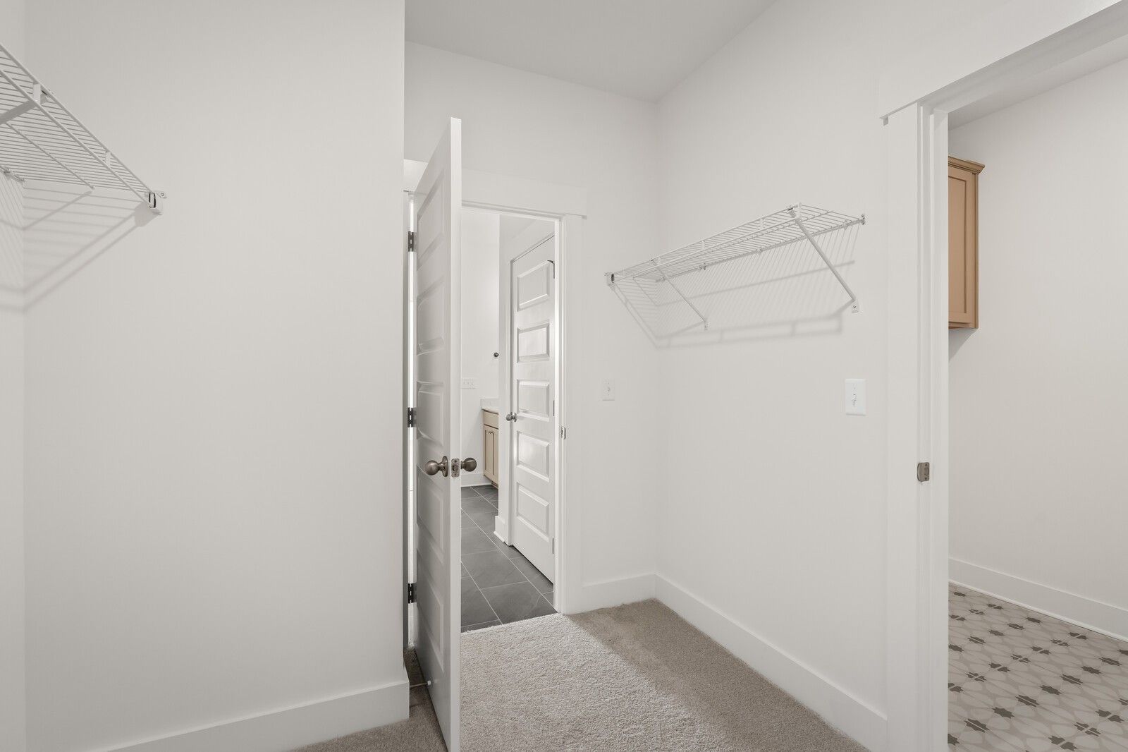 Spacious walk-in closet with wire shelving and en-suite bathroom door in Davidson Homes The Ash A, Gallatin, TN