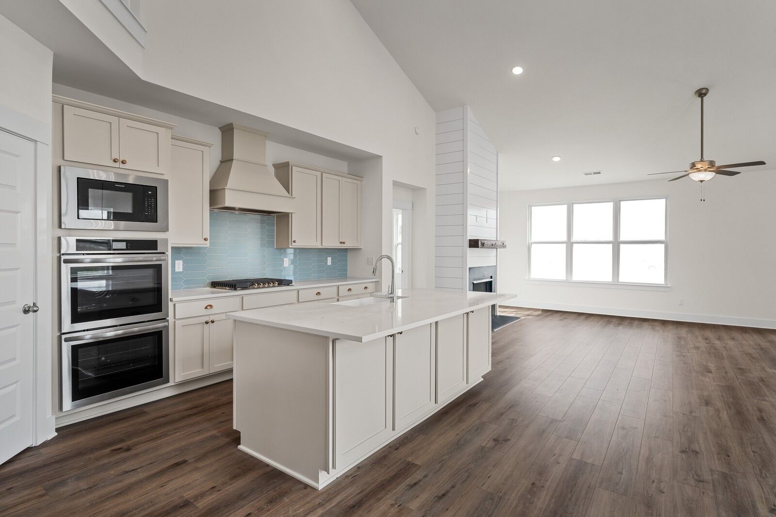 Modern kitchen featuring white shaker cabinets, blue subway backsplash, stainless double oven in The Ridgeport home, Gallatin, TN
