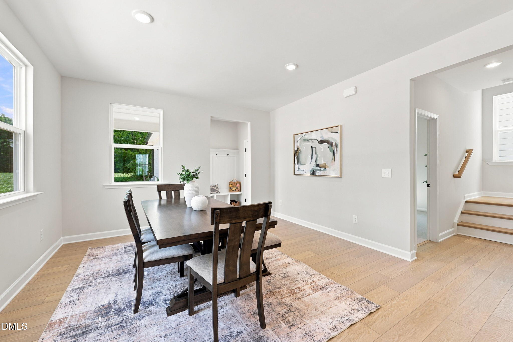 Bright dining room with wood table and hardwood floors in The Harris C floor plan at Forestville Yard, Knightdale, NC.