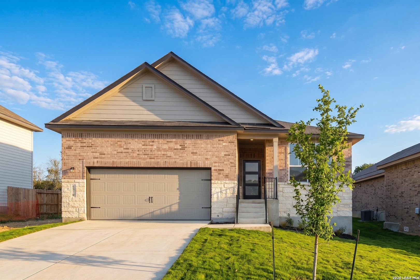 Single-story Glenwood F floor plan by Davidson Homes with brick exterior and 2-car garage in Royal Crest, San Antonio.