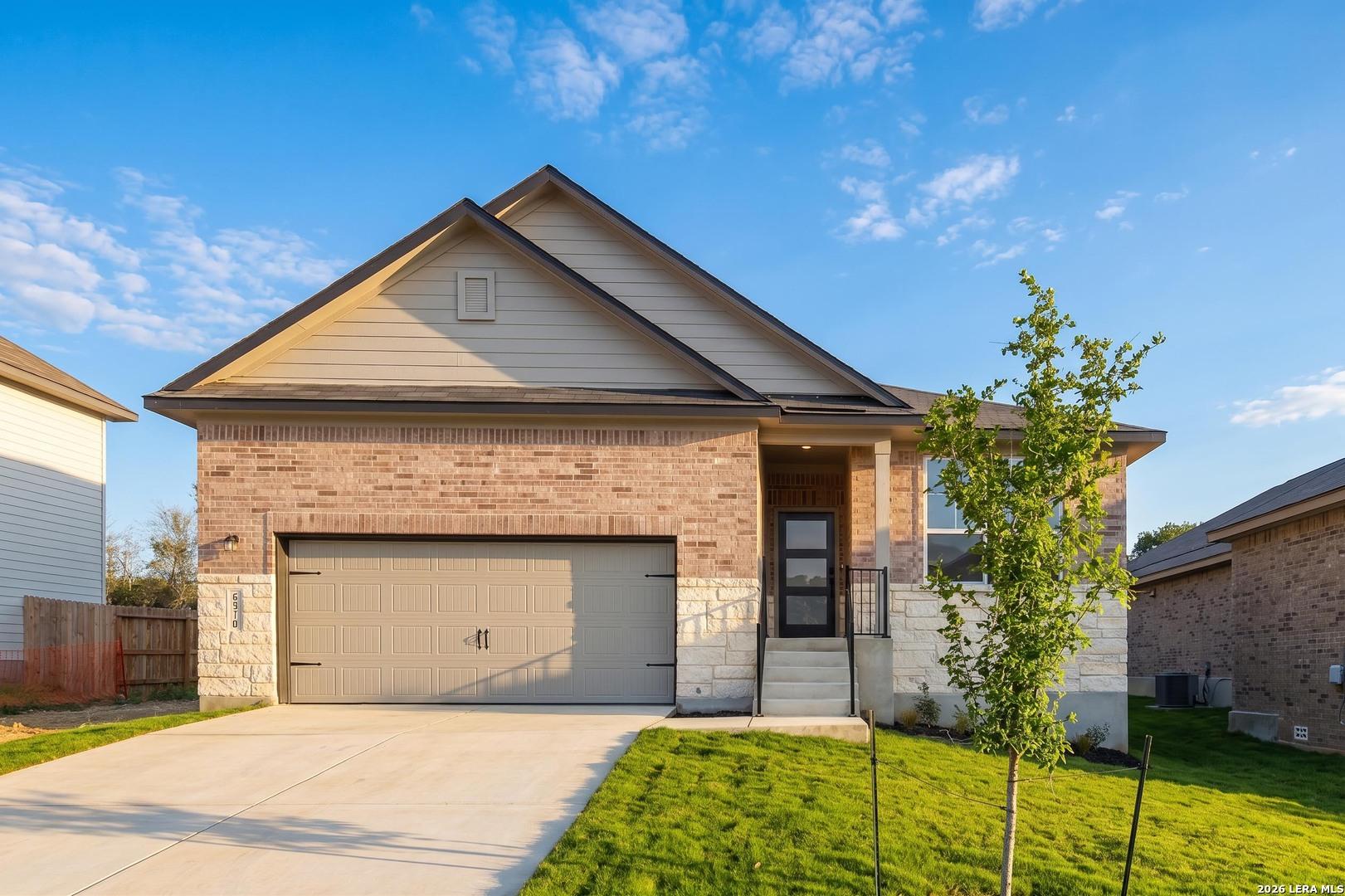 Single-story Glenwood F floor plan by Davidson Homes with brick exterior and 2-car garage in Royal Crest, San Antonio.