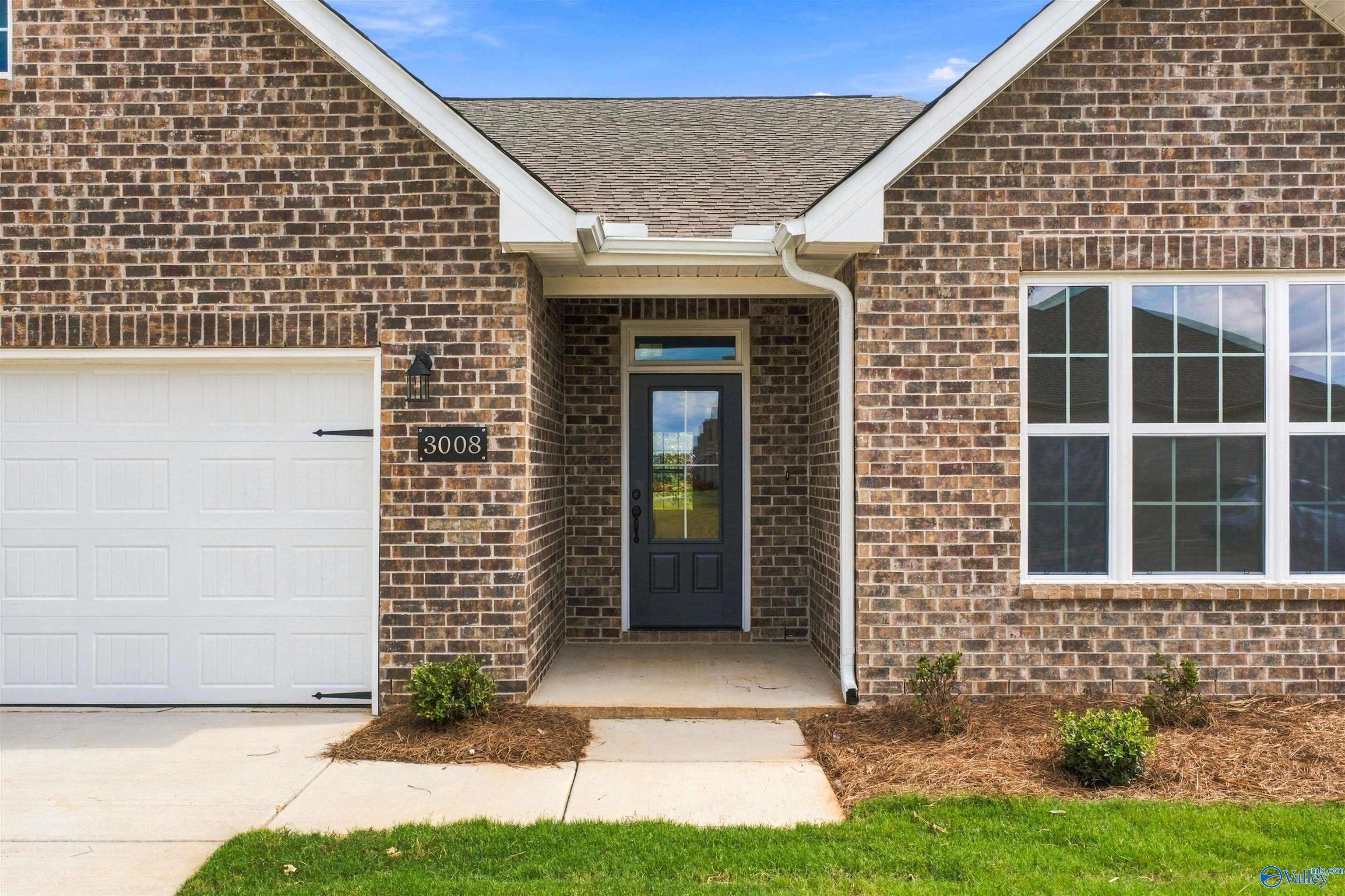 Brick front exterior with 2-car garage and covered entry of Davidson Homes' The Montgomery, 3-bedroom plan in Decatur, Alabama