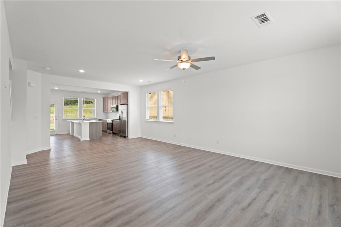 Open-concept living room and kitchen in The Stella D floor plan by Evermore Homes at Silver Oak in Cusseta, Alabama.