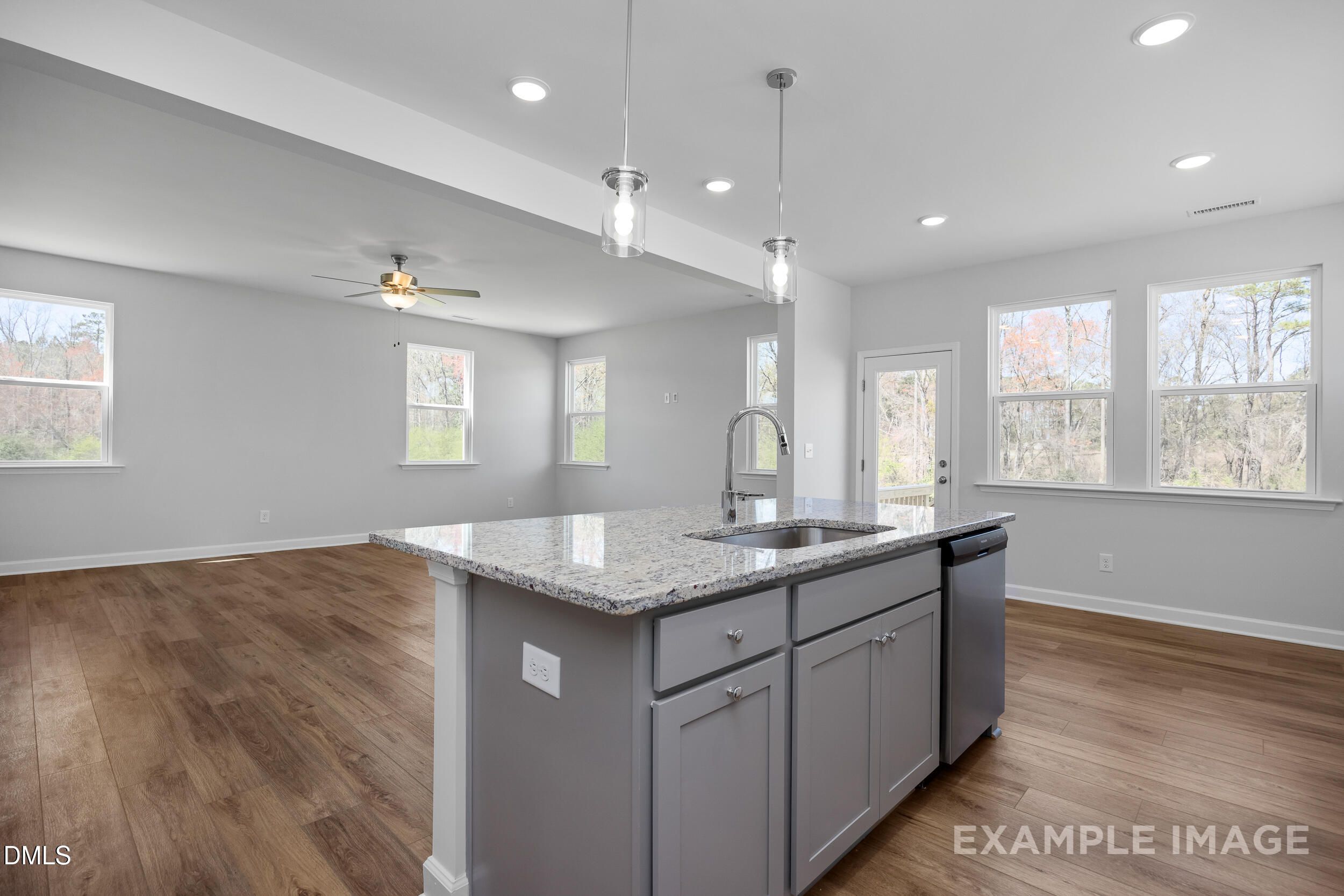 Open-concept kitchen with granite island in The Gavin A floor plan by Davidson Homes in Gregory Village, Lillington, NC.