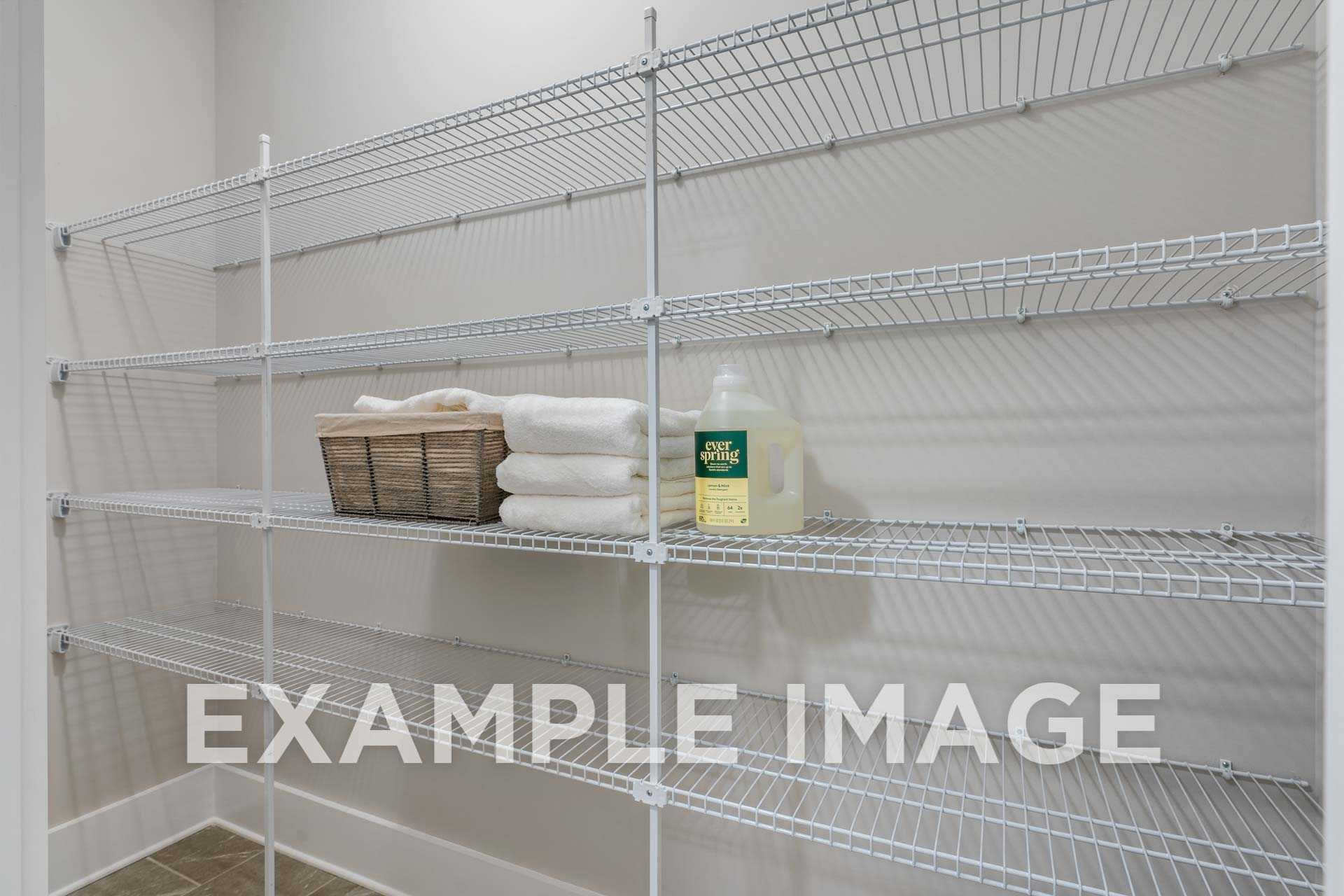 The Harrison home linen closet with white wire shelving, folded towels in basket, and green detergent bottle